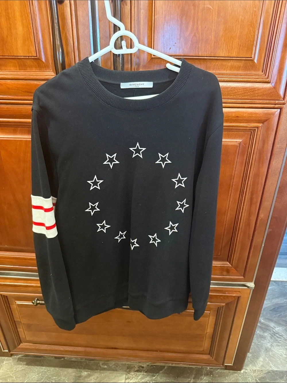 Givenchy Black Crewneck Sweater with White Star Circle and Red-Striped Sleeve
